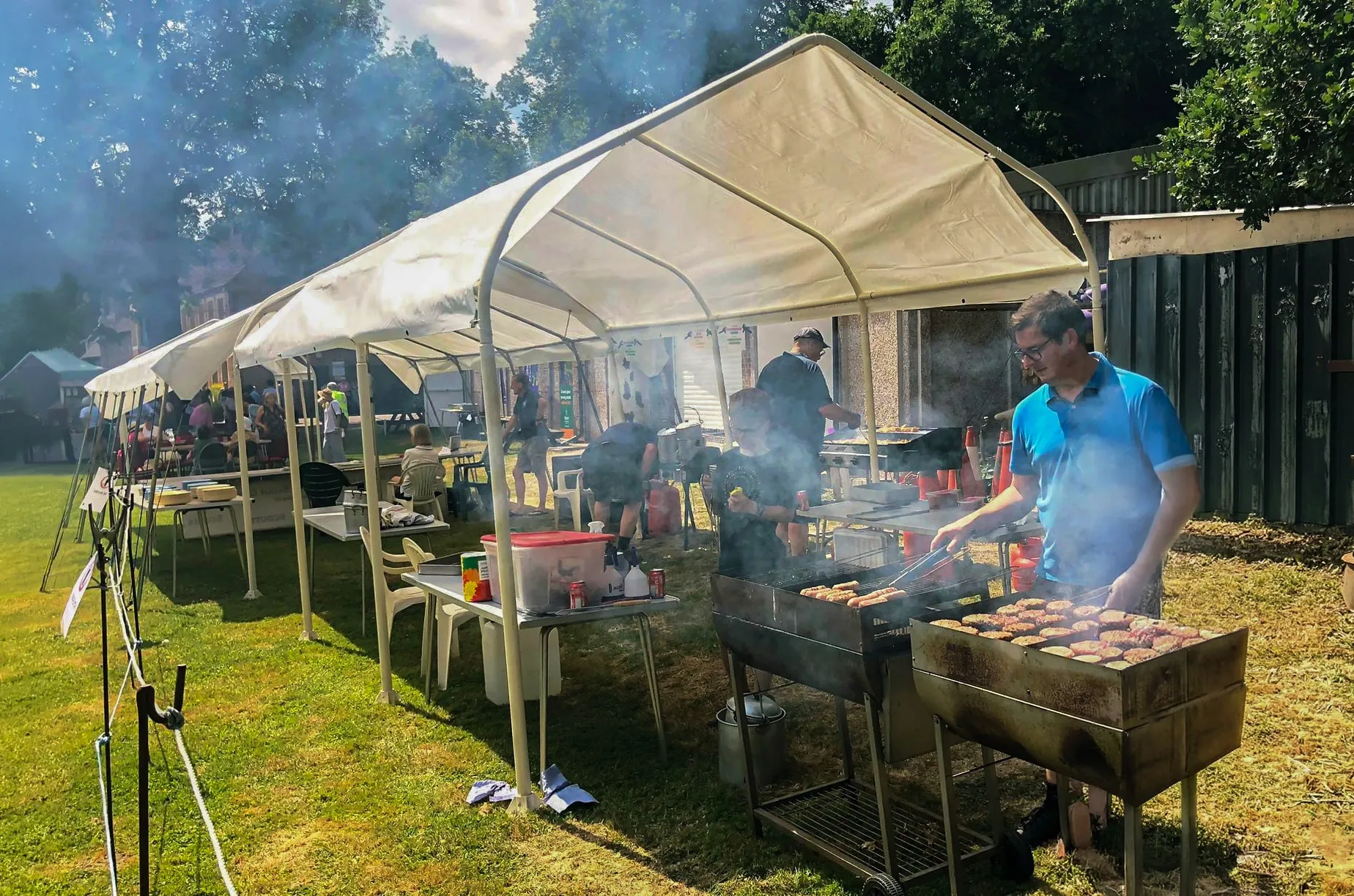 Lawrence Monk cooking on a BBQ with family and friends